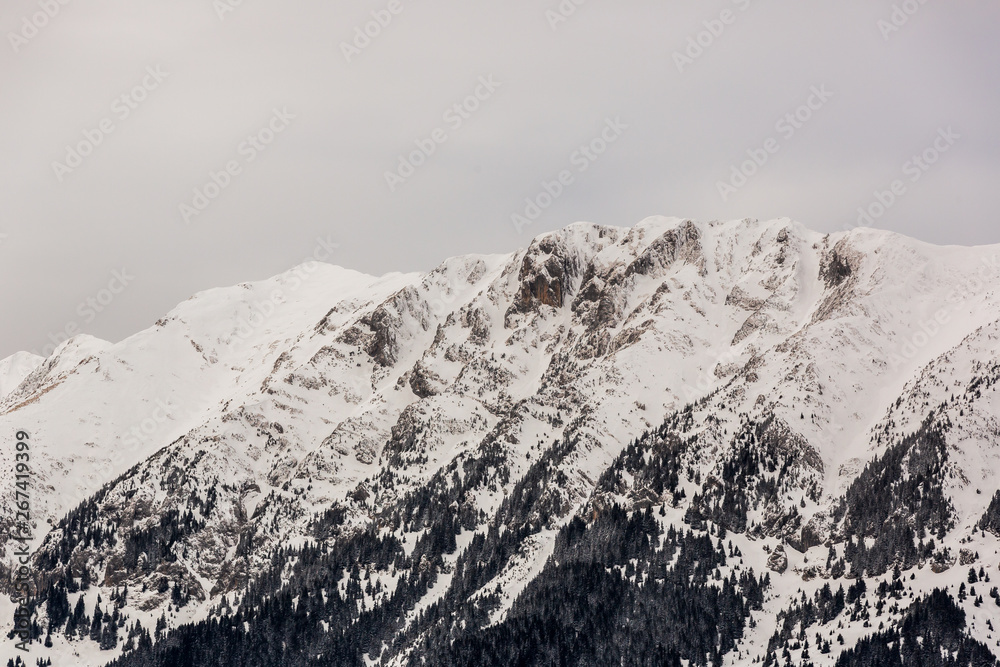 Winter snow covered mountain peaks in Brasov - Romania.