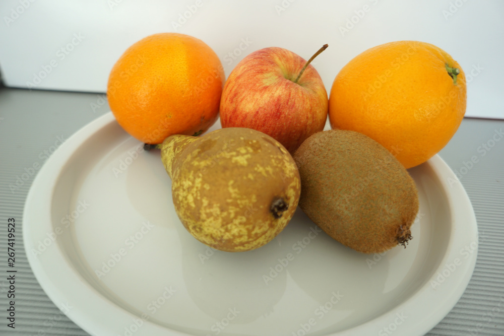 Fruit served on the tray and photographed on white plate