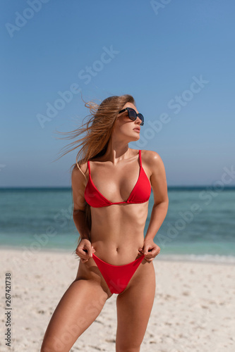 Beautiful sexy girl in a red bikini on the ocean