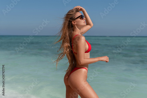 Beautiful sexy girl in a red bikini on the ocean