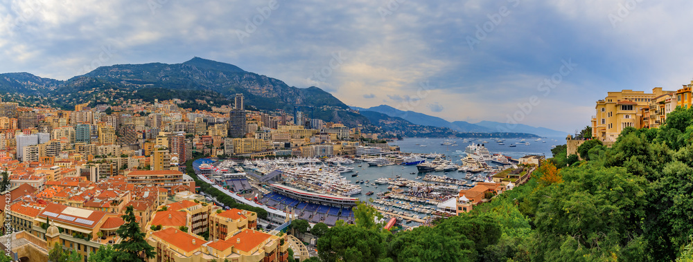 Monte Carlo panorama with luxury yachts and grand stands by the in harbor for Grand Prix F1 race in Monaco, Cote d'Azur