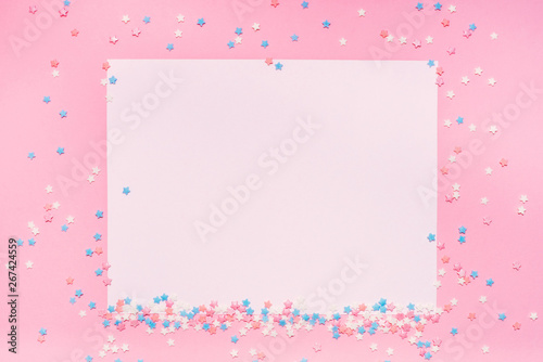 Little stars confetti on pink background. Holyday concept. Copy cpase for your text.