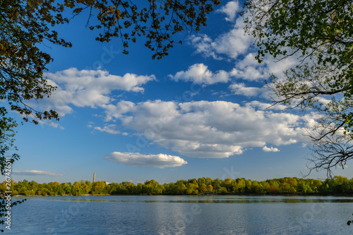 Fototapeta Naklejka Na Ścianę i Meble -  sunny summer day by the lake with blue water and white clouds in the sky