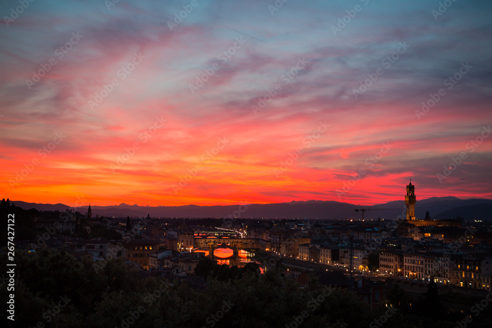 Amazing sky and Aerial view of Florence at sunset with the Ponte Vecchio and the Arno river. Tuscany, Italy