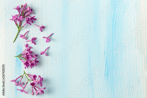 Lilac flowers on wooden background, space for text