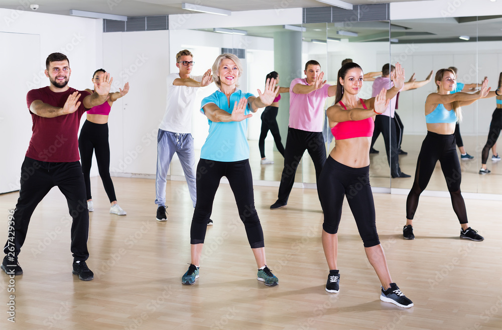 Fototapeta premium cheerful people dancing aerobics at lesson
