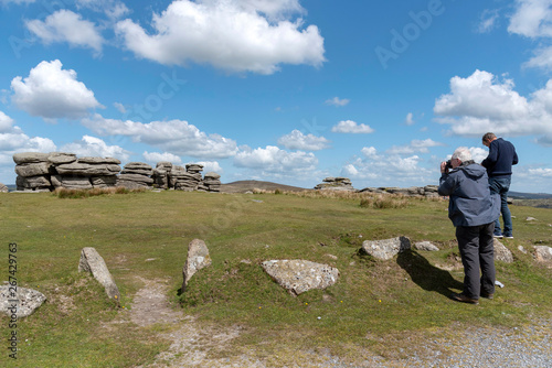 Dartmoor National Park, Devon, England, UK, May 2019. Men photographing the Combestone Tor high on Dartmoor a popular visiter location. photo