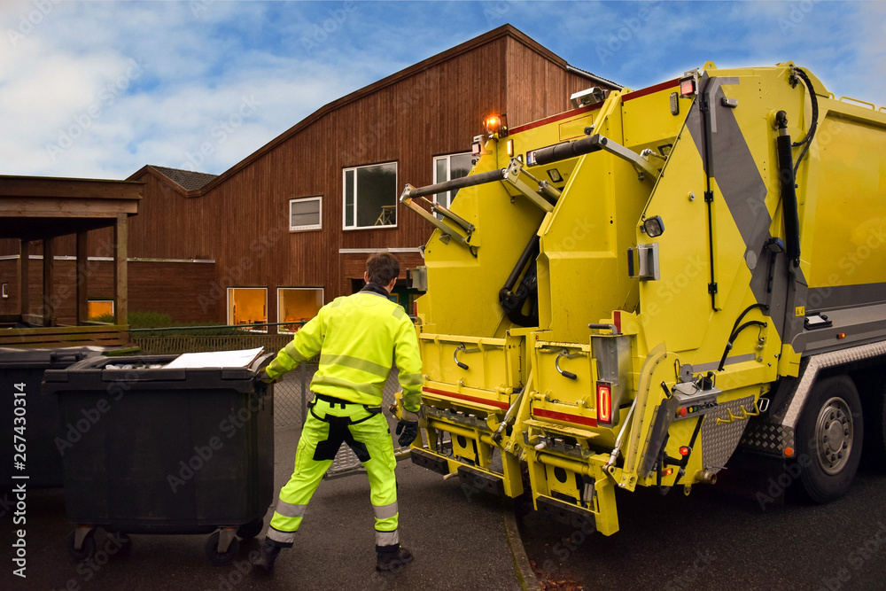 Garbage removal. Loading garbage in the garbage truck. Work garbage