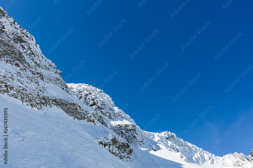 winter landscape with the mountain peaks covered by heavy snow. aerial view by drone. romanian mountains, Negoiu peak, Fagaras Mountains