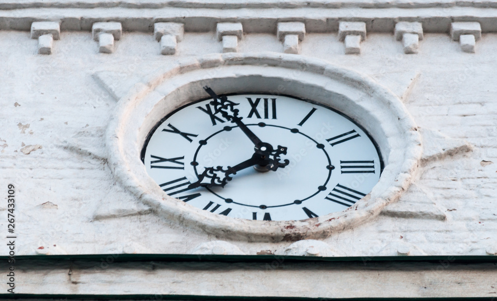 clock face from the clock tower. the hands of time. white dial. black arrows and black numbers. time.