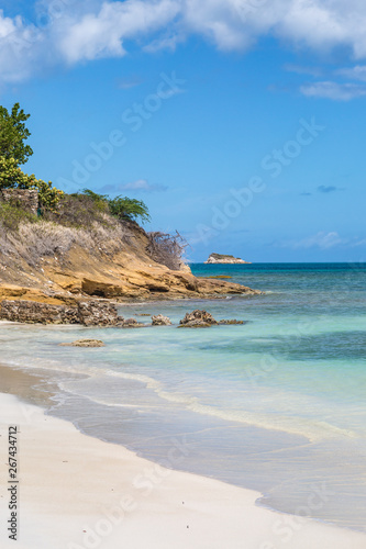 A sandy beach and rugged coastline on the Caribbean Island of Antigua