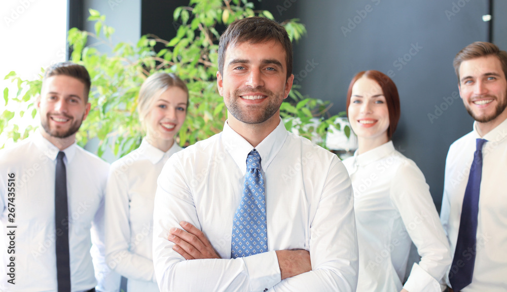 group of successful business people on the background of the office. group of successful business people on the background of the office.