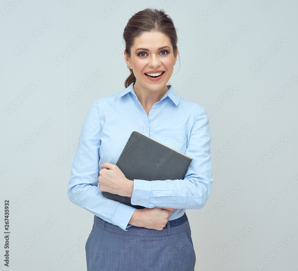  happy woman wearing blue shirt holding book.