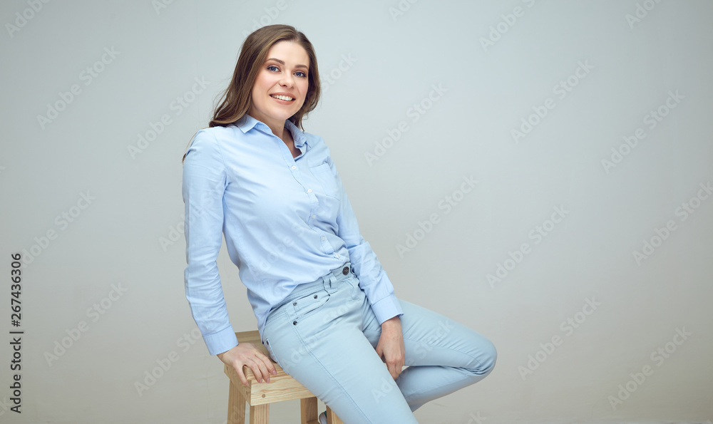 Smiling woman dressed in light blue shirt and pants Smiling woman dressed in light blue shirt and pants