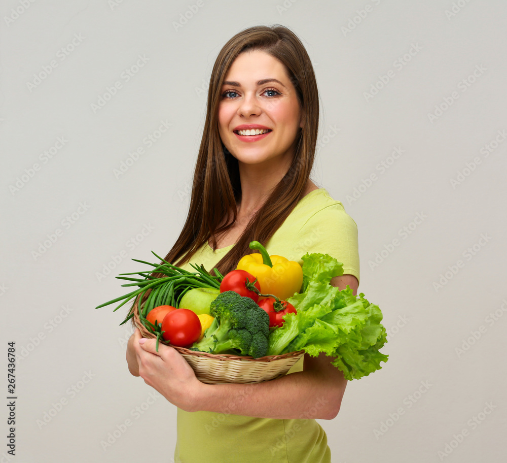 woman holding fresh vegetables and smiles with teeth. woman holding fresh vegetables and smiles with teeth.