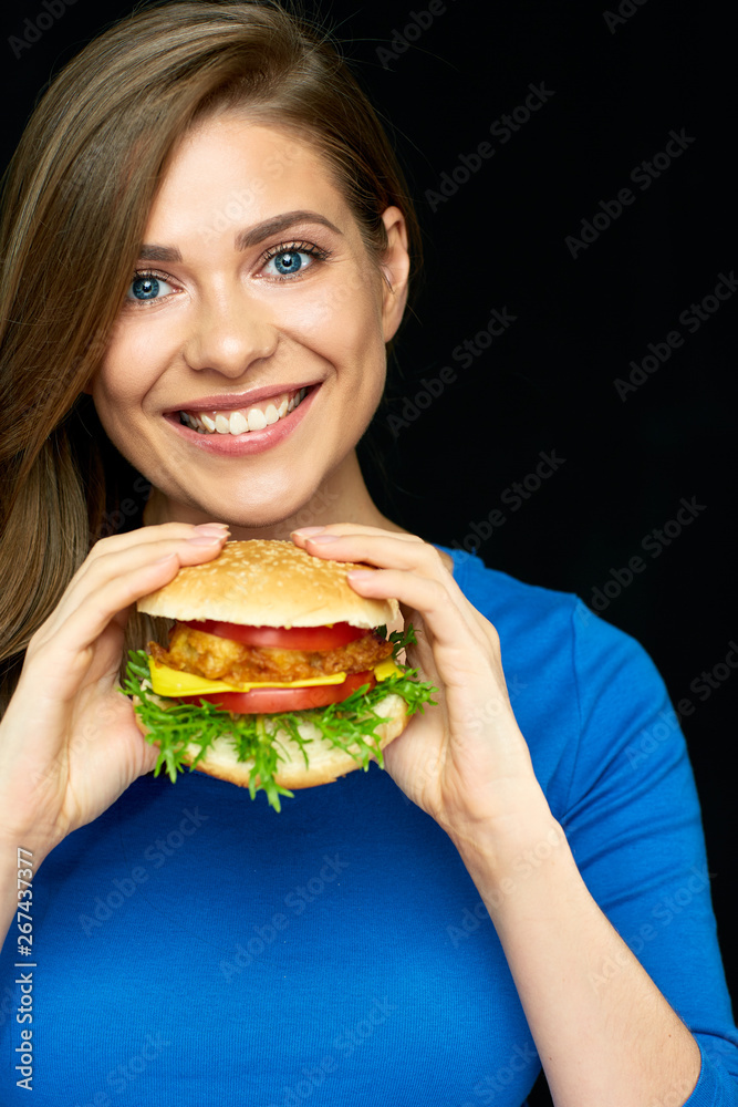 smiling woman holding big cheeseburger. smiling woman holding big cheeseburger.