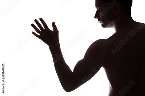 Young Muscular bodybuilder demonstrates his bicep on white background