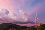 Gorgeous sunset on Kata beach view point. Electric wind turbine on pink cloudscape background. Phuket, Thailand. Shooted with Lens Baby Sweet 35mm with blurred soom effect.