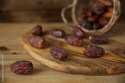 dates in a basket on wooden natural background