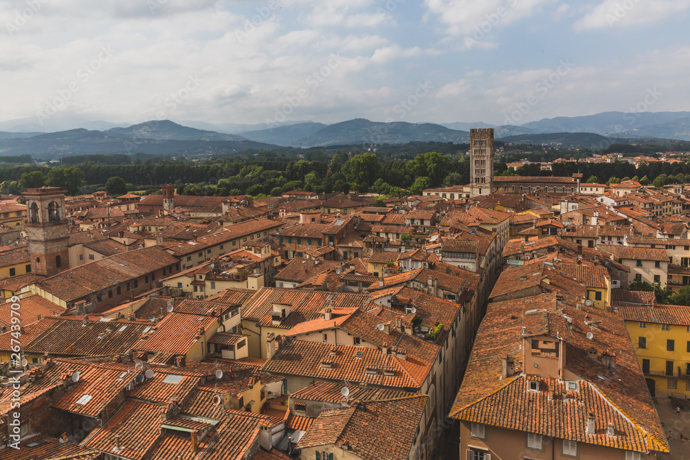 Architecture and buildings of Lucca, Tuscany, Italy, with mountain landscape in the distance