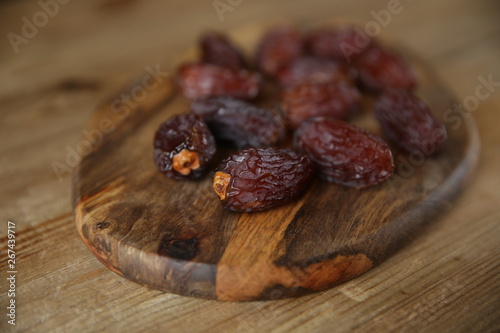 royal dates on a wooden board, wooden natural background, closeup
