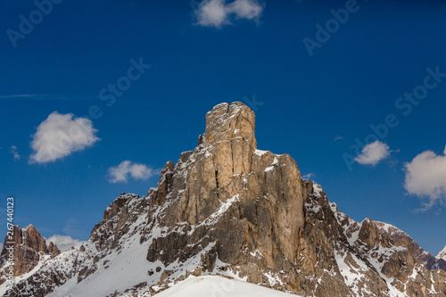 Beautiful winter landscape with snow in Alps. Dolomites. Panorama of snow mountain landscape with blue sky. Sunshine. Peaks. Rocks. Alps. Italy.
