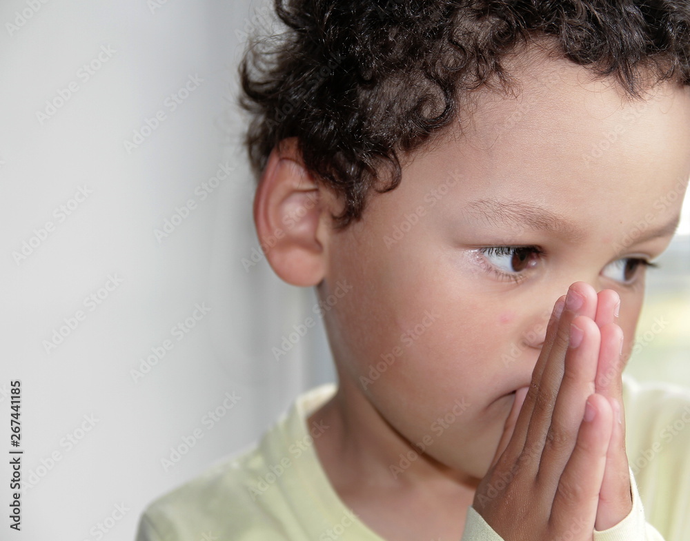 boy praying to God with hands held together stock photo boy praying to God with hands held together stock photo