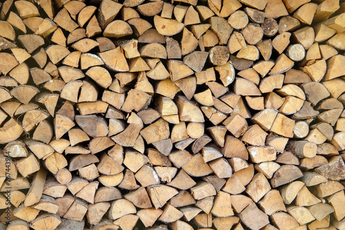 Wall firewood  Background of dry chopped firewood logs in a pile.Stack of wood for oven.