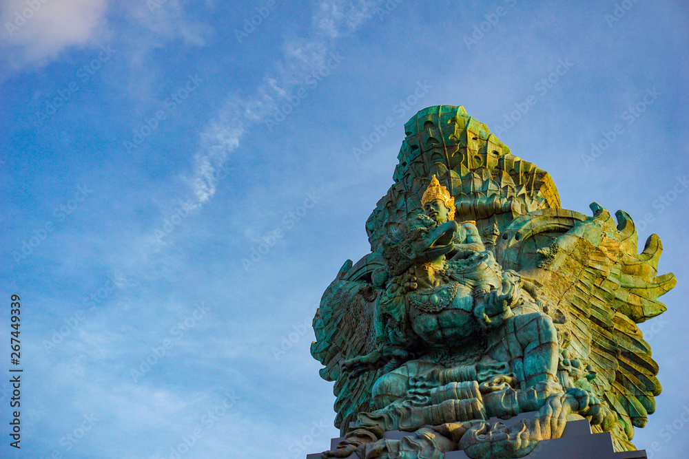 Picture of Garuda statue as Bali landmark with blue sky as a background. Balinese traditional symbol of hindu religion