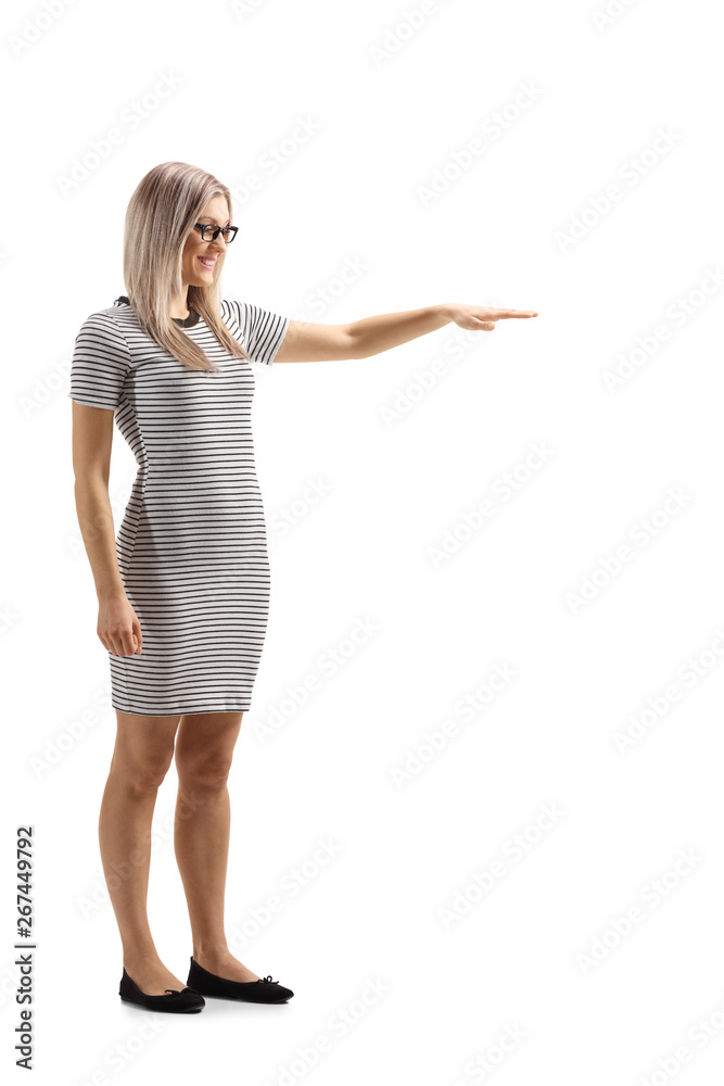Young woman gesturing with hand and showing the height of something Young woman gesturing with hand and showing the height of something