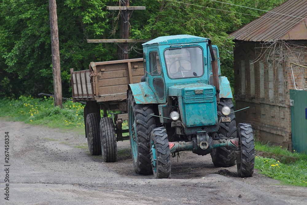 tractor near the house in the countryside tractor near the house in the countryside