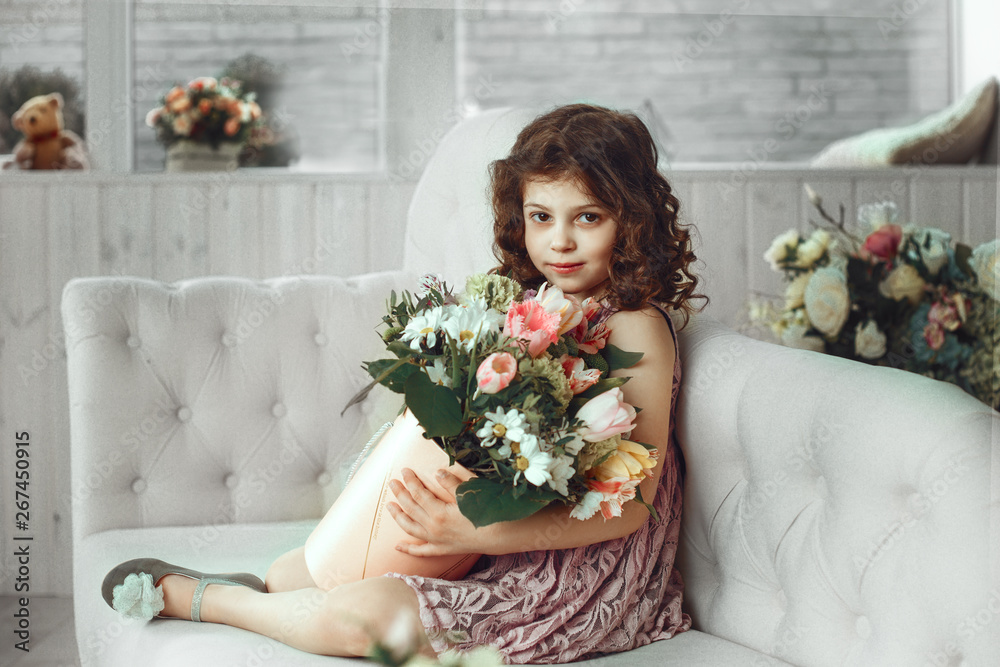 Beauty portrait of curly girl with flowers