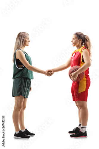 Two female basketball players shaking hands
