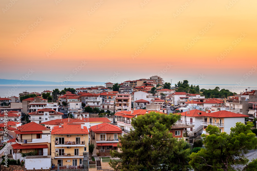 Golden hour view of amazing Neos Marmaras cityscape in Greece from a nearby vantage point