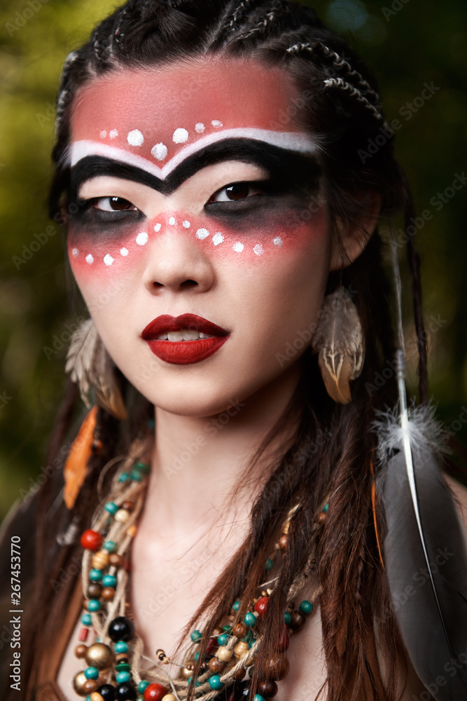 Fototapeta premium Outdoor close-up portrait of pretty young shamaness (witch doctor)