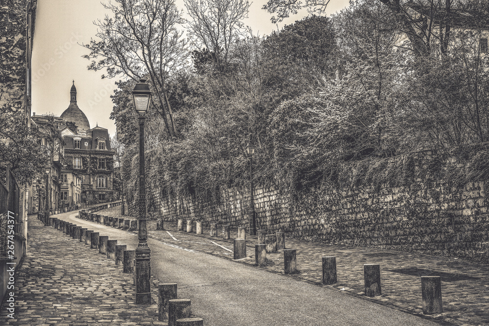 Paris / France. View of the famous street, Rue de l'Abreuvoir, known for its charming and historic architecture, in the Montmartre neighborhood. Monochrom