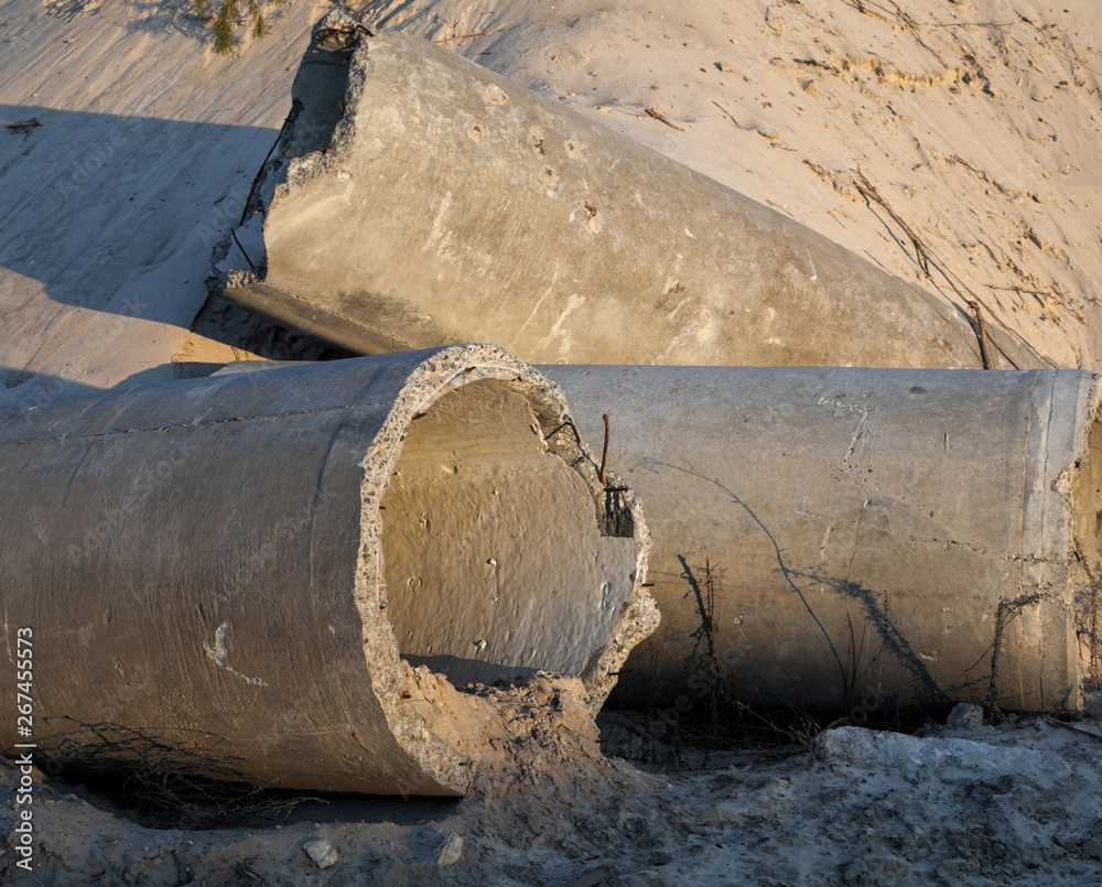 Concrete pipes (tubes) near the sand pile