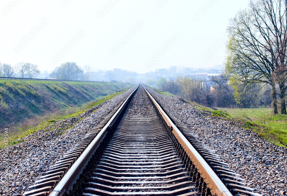 railway tracks on the outskirts of the city in the early morning - obrazy, fototapety, plakaty 