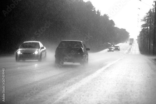 The car goes on the road in a downpour. out of focus image, blurry