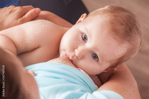 A young woman breast-feeding a baby