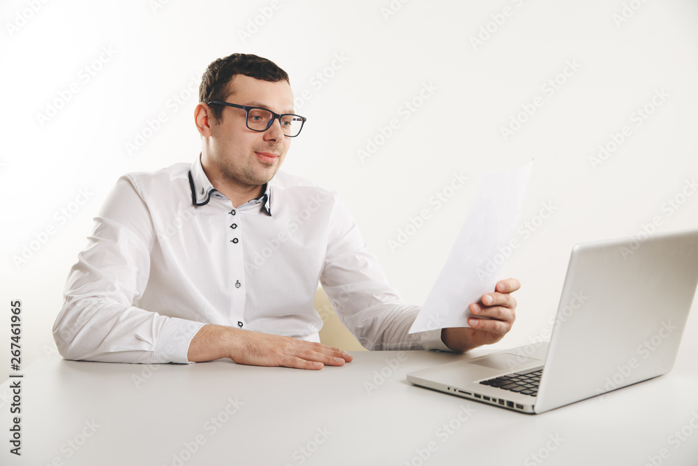 Man working with documents in office infront of the laptop
