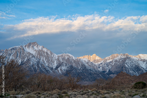 sunlight snowy peak Sierra Nevada mountains California © mariekazalia