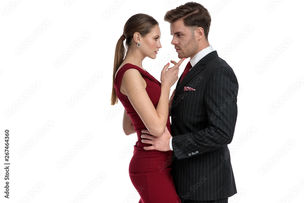 Charming man holding his girlfriend by the hips Charming man holding his girlfriend by the hips