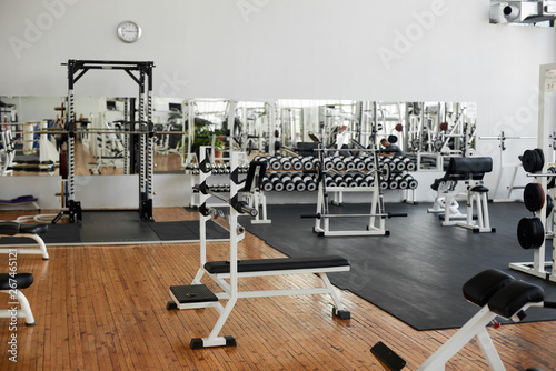 Gym interior with equipment. Modern fitness center with training equipment. Commercial gym interior design.