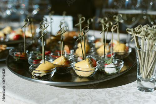 Cocktail with champagne and small toasts on a skewer. Snacks from strawberry  cheese  olives