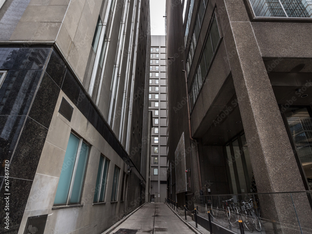 Fototapeta premium Dead end street at the bottom of skyscrapers in downtown Toronto, ontario, Canada, in the CBD. Toronto is a major north American economy hub