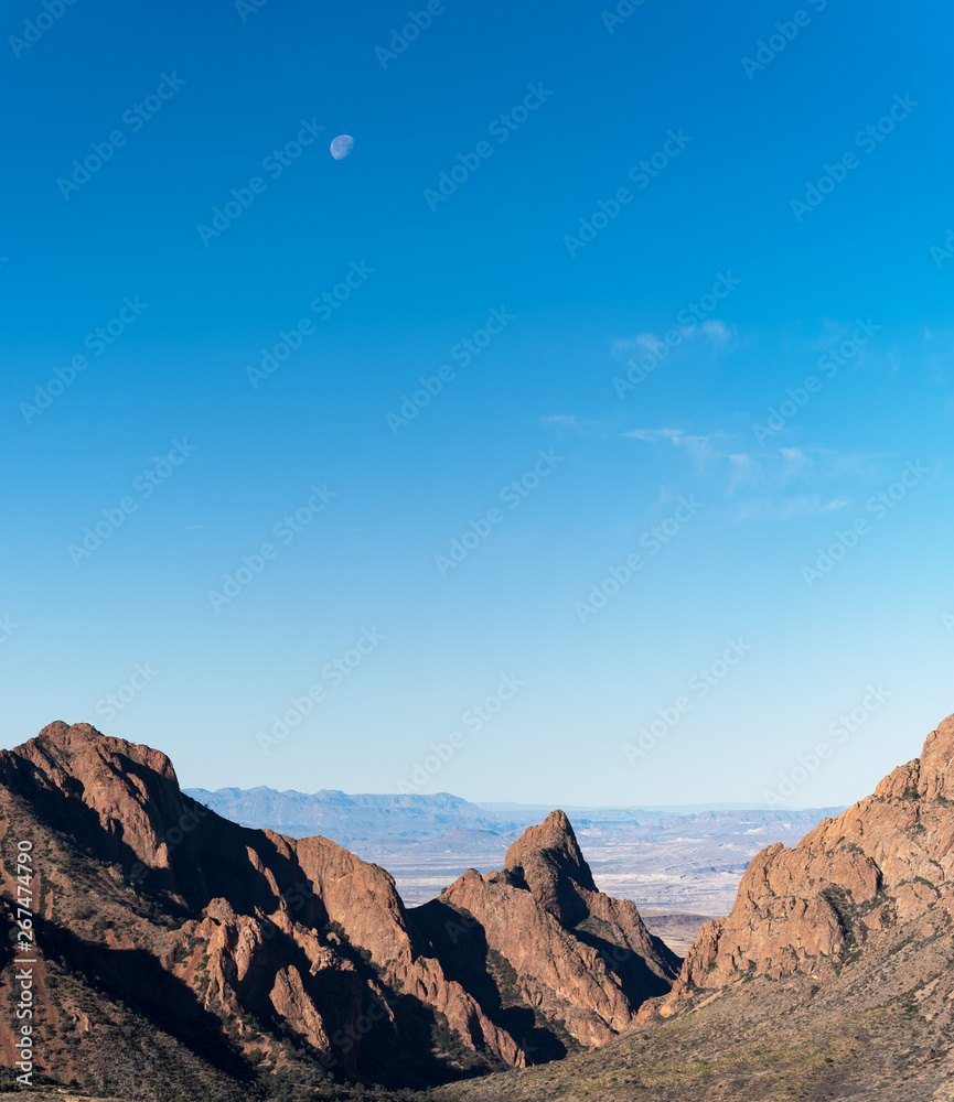 The Window part of the Chisos Mountain Range opens up into the desert valley with the moon above