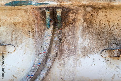 Old connecting pipes of a kitchen mixer close-up. © Yevhenii