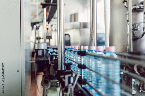 Bottling plant - Water bottling line for processing and bottling carbonated water into bottles. Selective focus.