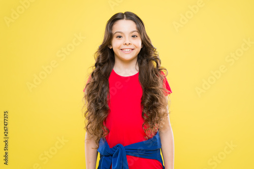 little girl smiling. fashion and beauty. hipster child. childhood happiness. hairdresser salon. skincare and natural hair. happy girl with long curly hair. healthy smiling. be happy and smiling